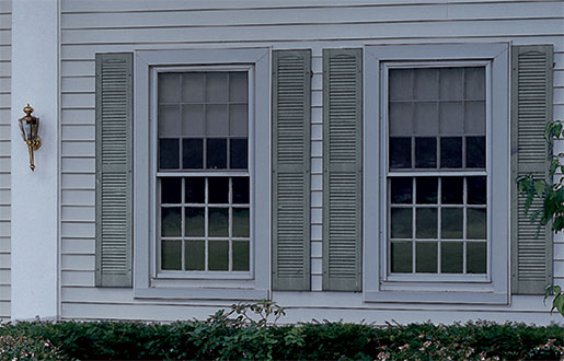 Close up of House with Alcoa Louvered Vinyl Shutters in Custom Shutter Sizes