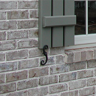 Shutter Tiebacks Pictured on a Brick House