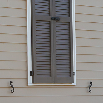 S Shutterdog Mounted Next to a Window