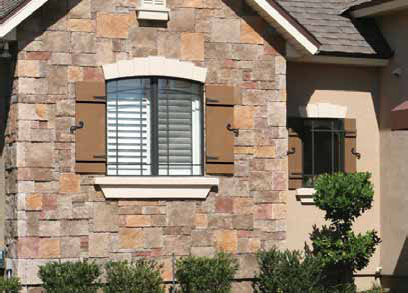 Faux Stone House with Closed Board and Batten Exterior Shutters