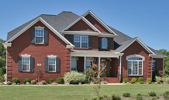 Brick House With Raised Panel Wooden Shutters